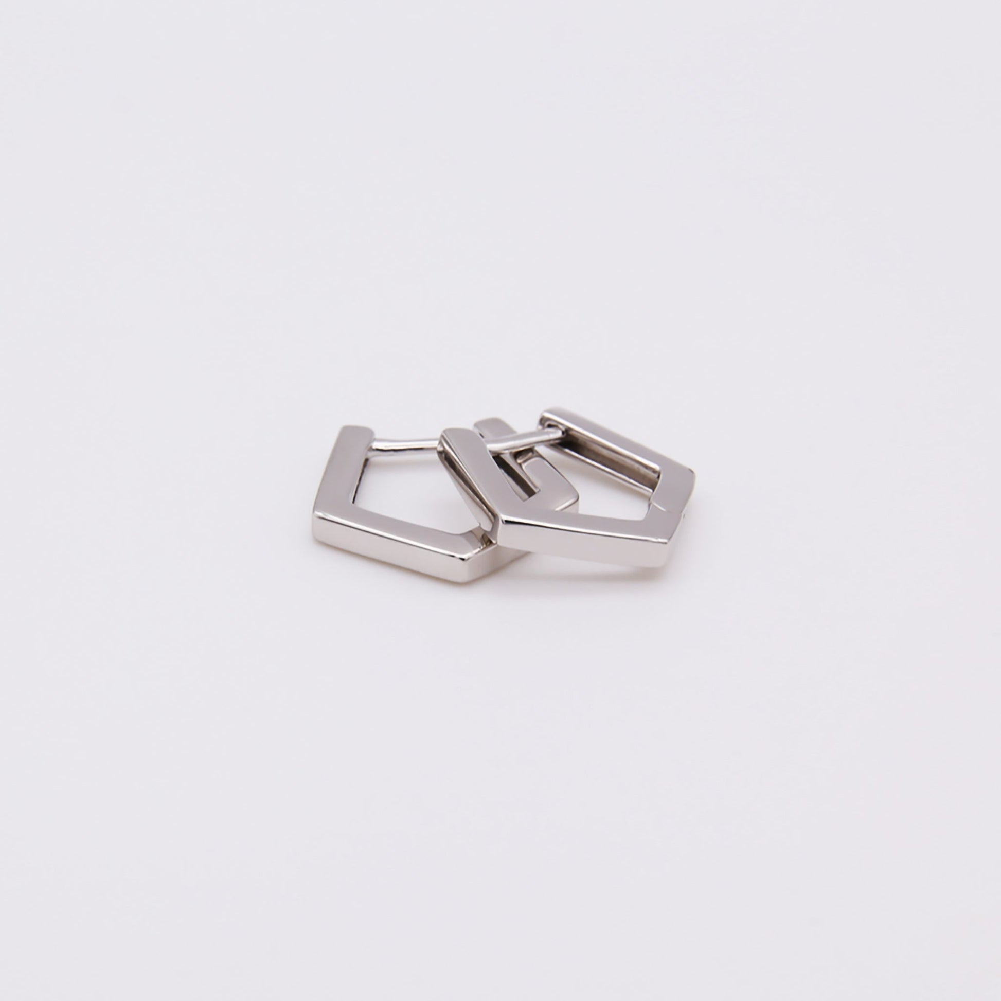 Sterling silver pentagon huggies earrings